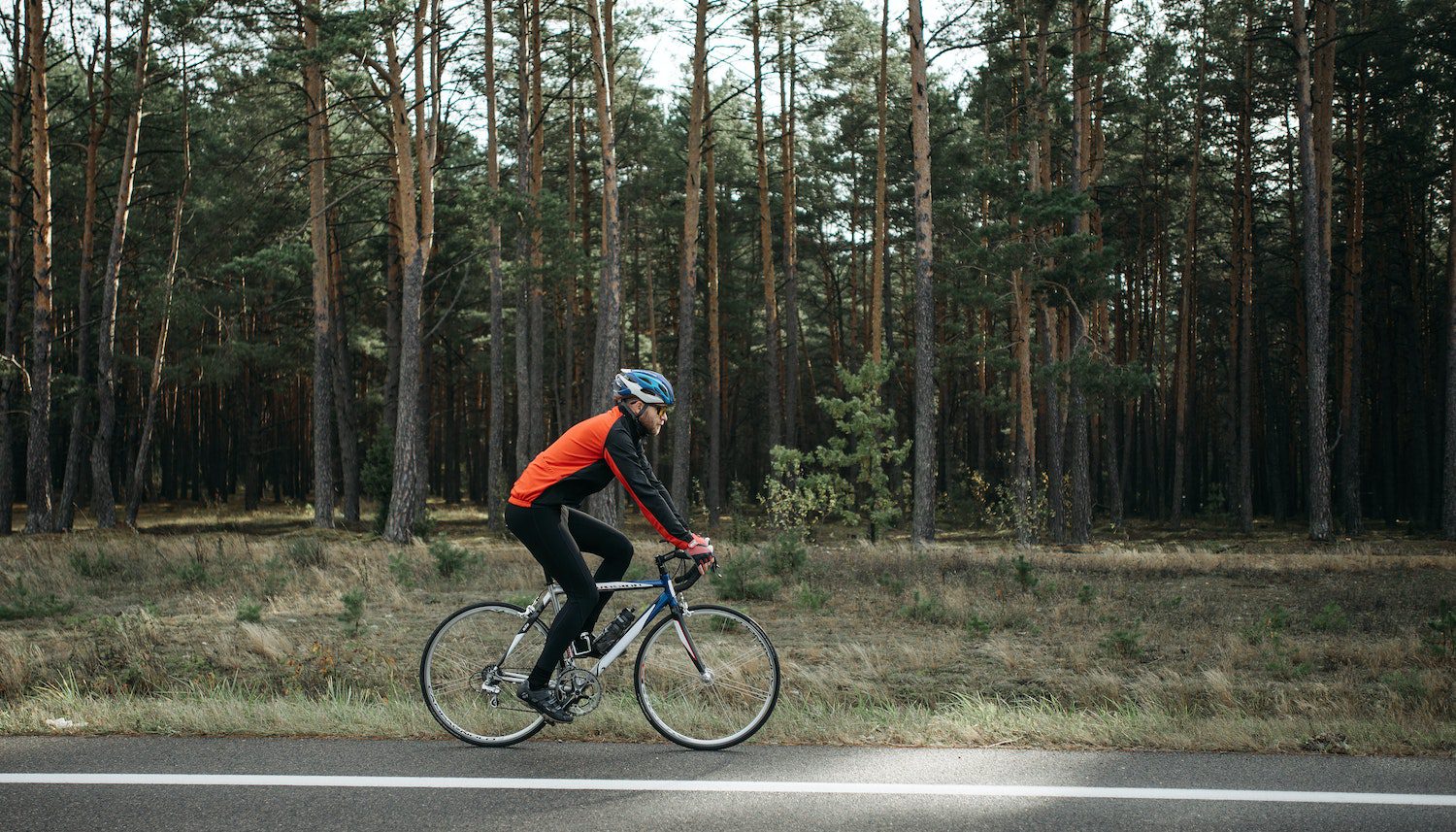 Man riding Black Bicycle on Roadside Man riding Black Bicycle on Roadside